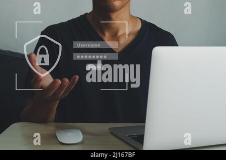 Uomo che utilizza il nome utente e la password della pagina di accesso del computer portatile su uno schermo virtuale. Concetto di tecnologia aziendale. Foto Stock