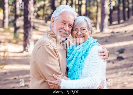 Coppia anziana felice che si abbraccia a vicenda nella foresta Foto Stock