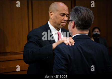 Washington, Stati Uniti. 23rd Mar 2022. Il senatore Cory Booker (D-N.J.) si congratula con Patrick Jackson, marito del candidato, dopo la conclusione delle audizioni di conferma del Comitato giudiziario del Senato per la nomina del giudice Kentanji Brown Jackson alla Corte Suprema, presso il Campidoglio degli Stati Uniti, a Washington, DC, mercoledì 23 marzo, 2022. Nel corso delle audizioni di conferma della Corte Suprema del Senato, i senatori discuteranno a lungo il Nominee Kentanji Brown Jackson del Presidente Biden in un'audizione di maratona prima di porre ulteriori domande mercoledì. (Graeme Sloan/Sipa USA) Credit: Sipa USA/Alamy Live News Foto Stock