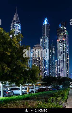 Dubai, Emirati Arabi Uniti - Dicembre 05 2021: Vista verticale dei grattacieli di Dubai Marina con parcheggio auto di fronte alla notte az; carta da parati di Dubai Foto Stock