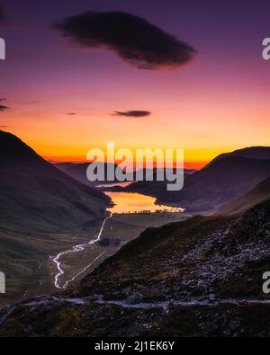 Serata nel Lake District inglese. Nuvola sul cielo viola e arancione sopra il lago Buttermere. Vista da Warnscale. Foto Stock