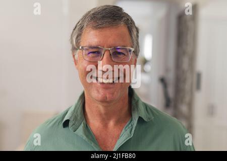 Primo piano ritratto di felice caucasico anziano in occhiali a casa Foto Stock