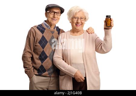 Uomo e donna anziani che tengono una bottiglia di pillole di fronte alla macchina fotografica isolato su sfondo bianco Foto Stock