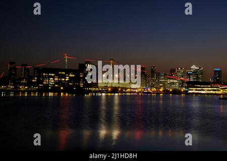 London, UK, 25th Mar, 2022. Al tramonto con Canary Wharf e l'edificio del 02 visibile come bel tempo e secco è destinato a continuare per il resto del fine settimana, prima di cedere il passo a più temperature stagionali la prossima settimana. Dopo che questa settimana è stato lanciato un avvertimento sull'inquinamento atmosferico elevato per Londra, venerdì la qualità dell'aria è rimasta scadente in alcune parti della città. Credit: Undicesima ora Fotografia/Alamy Live News Foto Stock