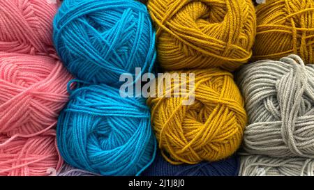 Filo di lana blu, giallo e rosa. Matasse multicolore di lana primo piano Foto Stock