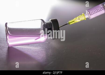 Nuovi vaccini medici pronti per il test con siringa e ampulla per iniettare la cura per l'immunizzazione in pazienti malati e deboli per guarire il loro COVID sofferto Foto Stock