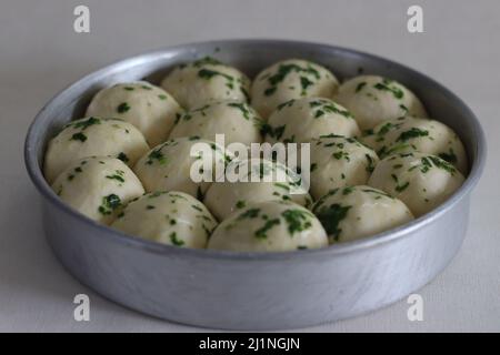 La pasta per la cena è pronta per andare al forno preparato in una teglia circolare. Glassato con burro, coriandolo tritato ed erbe. Sparato sul backgroud bianco Foto Stock