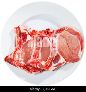 Pezzi di bistecche di lombo di maiale crudo Foto Stock