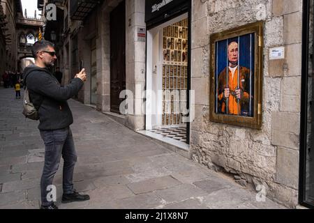 Barcellona, Spagna. 28th Mar 2022. Un uomo scatta una foto del ritratto di Vladimir Putin dietro i bar. Vladimir Putin Behind Bars è rappresentato nel nuovo collage grafico pubblico in Plaza de Sant Jaume dall'artista italiano TvBoy, con sede a Barcellona. (Foto di Paco Freire/SOPA Images/Sipa USA) Credit: Sipa USA/Alamy Live News Foto Stock