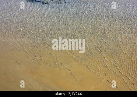 Piccole onde lucenti vicino al mare. Foto Stock