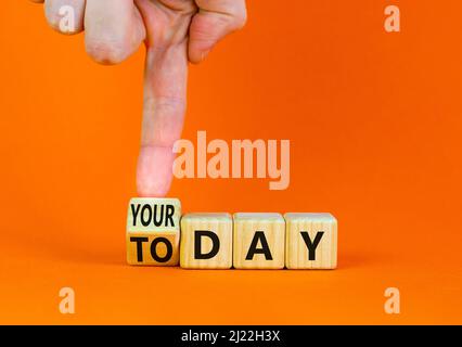 Oggi è il tuo simbolo del giorno. L'uomo d'affari trasforma il cubo di legno e cambia le parole di concetto oggi al vostro giorno. Bellissimo sfondo arancione, spazio copia. Busi Foto Stock