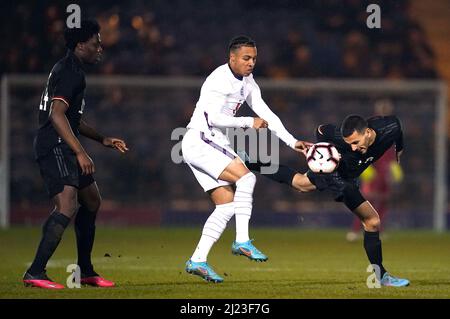 Cameron Archer in Inghilterra e Soufiane Messeguem in Germania (a destra) lottano per la palla durante la partita Under 20 Elite League allo stadio JobServe Community Stadium di Colchester. Data foto: Martedì 29 marzo 2022. Foto Stock