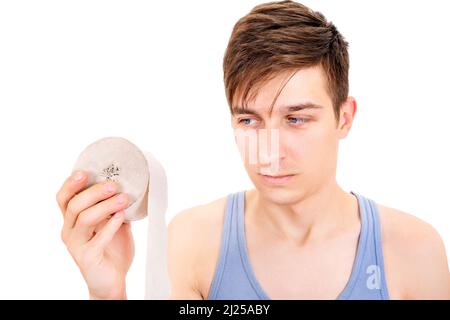 L'infelice giovane uomo con un carta igienica isolato sullo sfondo bianco Foto Stock