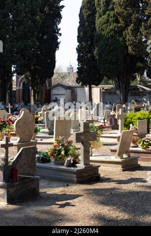 Cimitero murale italiano con lapidi e fiori artificiali in una soleggiata giornata estiva a Venezia, Isola di San Michele. Commemorazione dei morti, Foto Stock