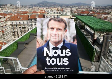 Nizza, Francia. 29th Mar 2022. Un uomo ha tenuto Emmanuel Macron elezioni presidenziali 2022 volantino con una vista delle proprietà a Nizza. Il primo turno delle elezioni presidenziali francesi del 2022 si svolgerà domenica 10th aprile 2022. (Foto di Dinendra Haria/SOPA Images/Sipa USA) Credit: Sipa USA/Alamy Live News Foto Stock