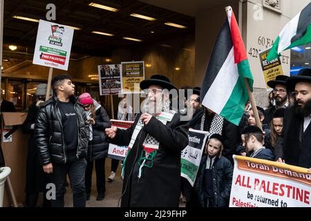 New York, Stati Uniti. 30th Mar 2022. Rabbi Weiss parla al raduno Pro Palestinese che si è tenuto in 42nd strada a Manhattan su Yawm al-Ard conosciuto come giorno della terra, il contrally per Israele è stato tenuto dall'altra parte della strada. Ai manifestanti pro-palestinesi si unirono ebrei ultra ortodossi della comunità Neturei Karta che si opposero all'esistenza di Israele come stato. La polizia ha separato gruppi di pro e contro palestinesi per la loro sicurezza. (Foto di Lev Radin/Pacific Press) Credit: Pacific Press Media Production Corp./Alamy Live News Foto Stock