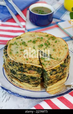 Cucina sveva, cucchiaio per torta di spinaci con pancake, flaedle stratificato, torta di pancake sul piatto, salsa alle erbe sul retro, salsa, specialità sveva Foto Stock