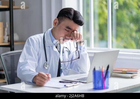 Immagine di un giovane medico asiatico che lavora in clinica Foto Stock