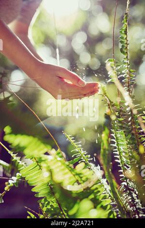 Pura come la Madre natura intendeva. Scatto ritagliato di una donna che lava le mani all'aperto. Foto Stock