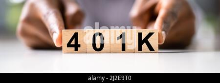 African American Man con 401K blocchi. Reddito denaro investimenti Foto Stock