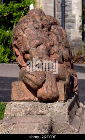Statua del leone che dorme in piedi guardia presso i giardini di Insole Court, Llandaff, Cardiff. Marzo. Primavera 2022. Foto Stock
