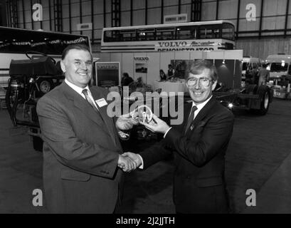 L'operatore della compagnia di pullman Harry Shaw (a sinistra) ha ricevuto il 15,0 00th Volvo B10 telaio da aggiungere alla sua flotta in crescita. È raffigurato che riceve le chiavi da Volvo Bus GB Sales Manager Bill Russell e la mostra Coach and Bus al NEC. 2nd novembre 1987. Foto Stock