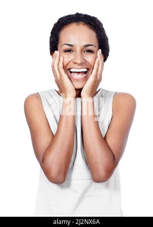 La shes ha ottenuto un sorriso vincente. Studio girato di una donna sicura che si posa su uno sfondo bianco. Foto Stock