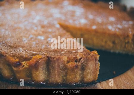 Bella torta di zucca dorata fatta in casa appena fuori dal forno e cosparso di zucchero bianco, pronto a mangiare. Foto Stock