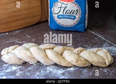 L'impasto intrecciato si solleverà e si cuocerà in una deliziosa pagnotta di pane di Challah Foto Stock