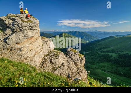 L'uomo e la donna durante le escursioni si siedono su Felskanzel, Predigerstuhl, Nockberge, Nockberge-Trail, Unesco Biosphere Park Nockberge, Gurktal Alpi, Carinzia, Austria Foto Stock