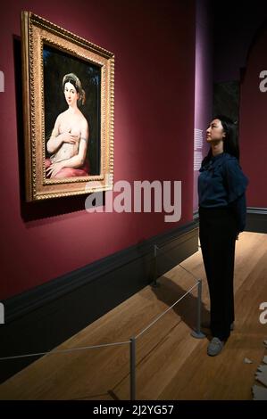 Londra, Regno Unito. (Imbarazzato fino alle 00,01 del 6th aprile 2022.) Anteprima stampa della mostra Credit Suisse : Raffaello, Gallerie First Floor, Galleria Nazionale, Trafalgar Square. Un dipendente di una galleria considera "Ritratto di una donna (la Fornarina)". Foto Stock