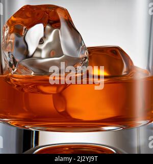 Vista macro di un elegante whiskey con cubetti di ghiaccio in un bicchiere. Concetto di bevanda analcolica. Foto Stock