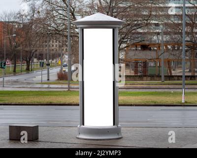 Colonna pubblicitaria in città. Mockup vuoto per testare i disegni dell'annuncio sul pilastro vicino alla strada. Modello per affissioni con un rettangolo bianco. Foto Stock