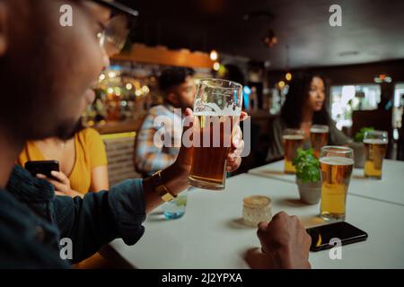 gruppo di amici diversi fuori per cena gustando una bevanda fredda Foto Stock
