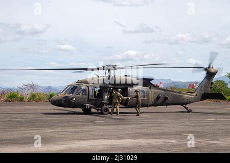 Una Marina statunitense assegnata al Marine Wing Support Squadron 172 (MWSS-172), e un soldato dell'esercito con la Brigata dell'Aviazione da combattimento del 25th, divisione di fanteria del 25th preparano a rifornire un elicottero dell'esercito UH-60 Hawk in un punto di armamento e rifornimento in avanti durante il Balikatan 22 a Subic Bay, Filippine, 3 aprile 2022. Balikatan è un esercizio annuale tra le forze armate delle Filippine e militari degli Stati Uniti progettato per rafforzare l'interoperabilità bilaterale, le capacità, la fiducia e la cooperazione costruita nel corso di decenni di esperienze condivise. Balikatan, Tagalog per “smaco a spalla”, è un’antica Foto Stock