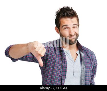 Sì, forse la prossima volta. Studio girato di un giovane uomo mostrando i pollici giù su uno sfondo bianco. Foto Stock
