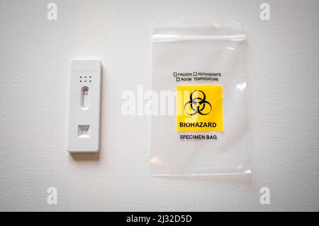 Immagine del prodotto Foto del prodotto negativo del test dell'antigene COVID accanto a Biohazard Small Clear Bag isolato su sfondo bianco. Superare la pandemia Foto Stock