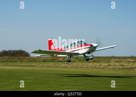 Grumman American AA-5B Tiger Plane G-BCRR decollo per correre in un round della Royal Aero Club Air Race al Great Oakley Airfield nella zona rurale dell'Essex, Regno Unito Foto Stock