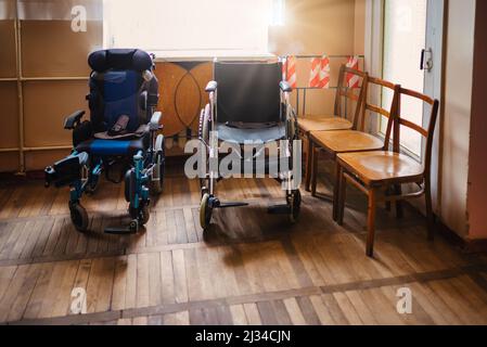 Sedia a rotelle vuota parcheggiata nel corridoio dell'ospedale, ospedale per sedie a rotelle Foto Stock