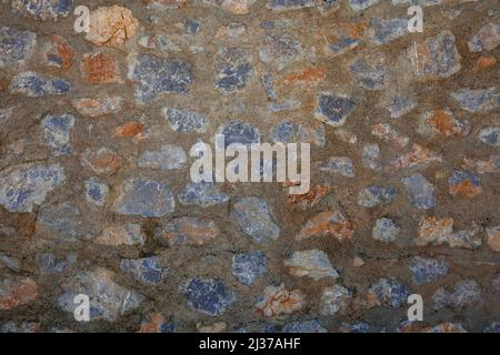 Lo sfondo della pietra. Ed un muro di pietra con un rapporto di cemento di overused. Foto Stock