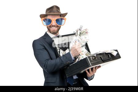 Fare soldi lavorare a vostro favore. Showman tenere la valigia con denaro. Uomo ricco Foto Stock