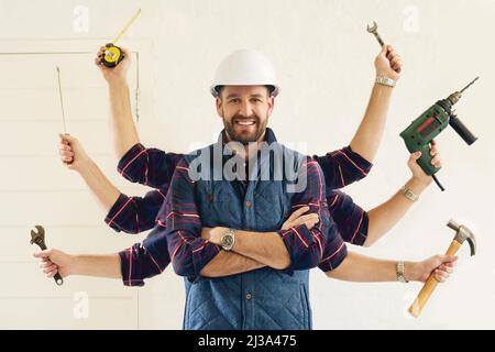 HES ha tutti gli strumenti di cui hai bisogno. Ritratto di un bel giovane strumento mano in più mani. Foto Stock