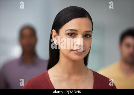 I team di successo hanno bisogno di un leader sicuro. Ritratto di un gruppo di giovani imprenditori fiduciosi che lavorano in un ufficio moderno. Foto Stock