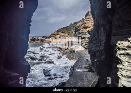 Buco nella parete naturale formazione rocciosa a Thompsons baia spiaggia ballito Sud Africa Foto Stock