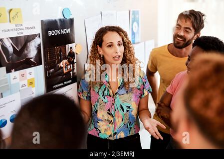 State vedendo il quadro più grande. Scatto corto di una giovane designer attraente che dà una presentazione nella sala riunioni. Foto Stock