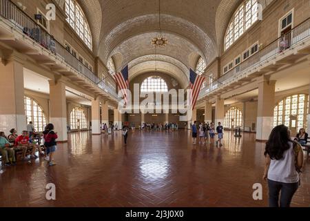 ELLIS ISLAND, New York City, NY, USA, la grande sala dell'Ellis Island National Park, interni, persone, bandiere americane Foto Stock