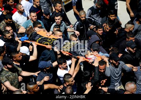Jenin, Palestina. 09th Apr 2022. 9 aprile 2022, Jenin, Cisgiordania, Palestina: Jenin, Cisgiordania, Palestina. 09 aprile 2022. I palestinesi nel campo profughi di Jenin, nella Cisgiordania settentrionale, trasportano il corpo di Ahmad al-Saadi, 23 anni, che è stato ucciso durante un grande raid israeliano nel campo profughi di Jenin nella Cisgiordania settentrionale. Si ritiene che al-Saadi sia stato affiliato al movimento palestinese della Jihad islamica. Almeno 13 palestinesi hanno subito ferite da proiettile, tra cui una donna di 19 anni, durante i pesanti scontri che si sono verificati durante il raid. il raid segue l'uccisione da parte di Israele Foto Stock