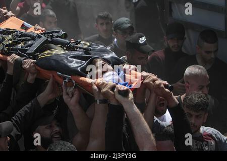 Jenin, Palestina. 09th Apr 2022. (NOTA DEL REDATTORE: Immagine raffigura la morte) i lutto trasportano il corpo di Ahmed al-Saadi, 24, che è stato ucciso durante un raid dell'esercito israeliano sul campo profughi di Jenin in Cisgiordania. Fonti mediche palestinesi hanno detto che 15 palestinesi sono stati feriti durante il raid. Credit: SOPA Images Limited/Alamy Live News Foto Stock