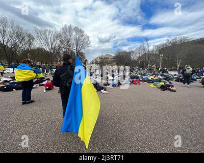 09 aprile 2022 Washington DC USA sostenitori per l'Ucraina dimostrazione di scena di fronte alla Casa Bianca giacente sul terreno per simulare i morti come nomi dei morti erano morti a!oud. Foto Stock