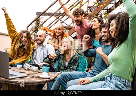 I giovani esultano guardando lo schermo di un computer portatile - concetto di obiettivo nello sport o successo Foto Stock